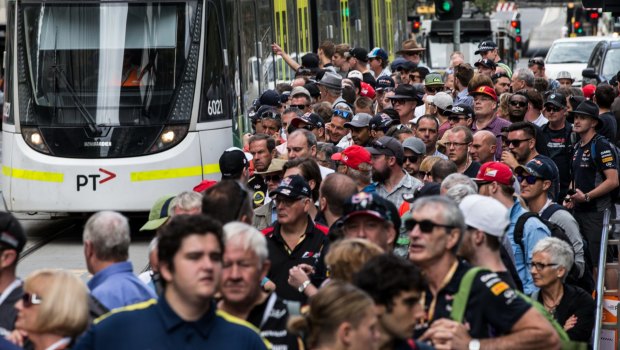 Big crowds wait to catch trams to the grand prix at Albert Park last year. 