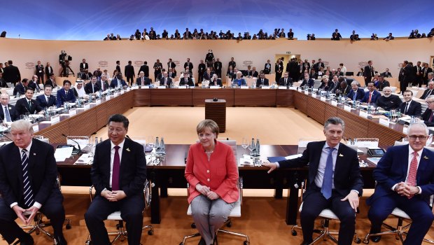 From left:  US President Donald Trump, China's Xi Jinping, Angela Merkel, Argentinian President Mauricio Macri and Prime Minister Malcolm Turnbull turn around for photographers at the G20 meeting in Hamburg in July.