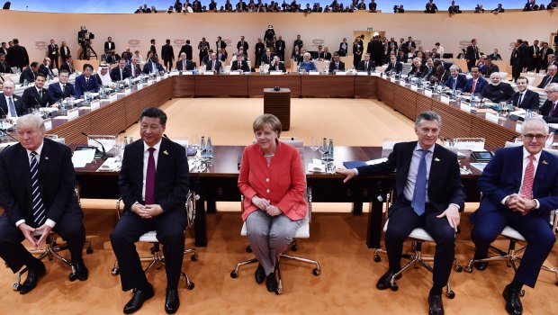 From left:  US President Donald Trump, China's Xi Jinping, Angela Merkel, Argentinian President Mauricio Macri and Prime Minister Malcolm Turnbull turn around for photographers at the G20 meeting in Hamburg in July.