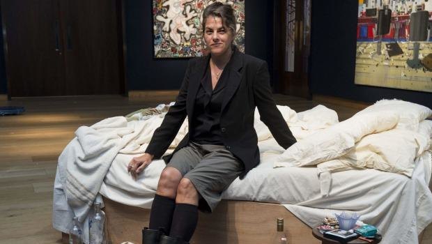 Tracey Emin sits on her iconic art installation, My Bed, which was short-listed for the 1999 Turner Prize. 