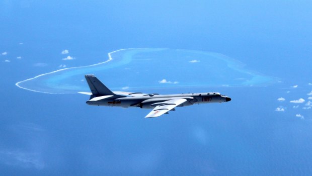 A Chinese plane patrols the islands and reefs in the South China Sea. 