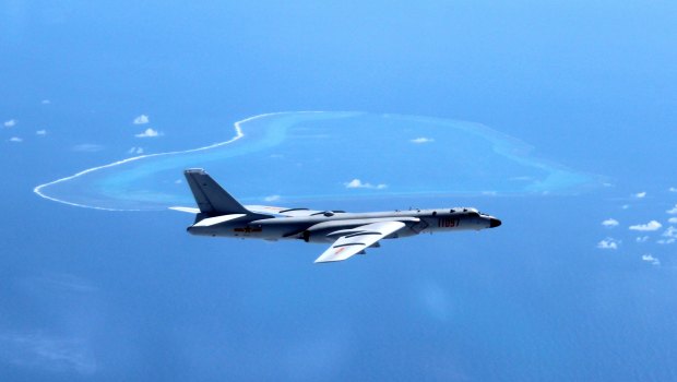 A Chinese plane patrols the islands and reefs in the South China Sea. 