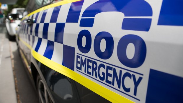 A barefoot armed robber alleged to have held up a service station in Melbourne's south-east before he smashed a luxury car into other vehicles has been charged by police.