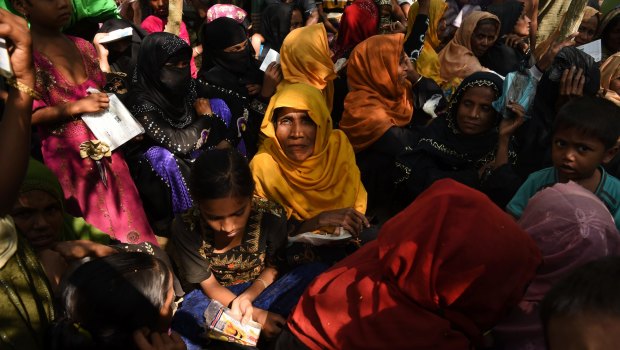 Women and children queue at a Red Cross distribution point in Burma Para refugee camp in Bangladesh. 