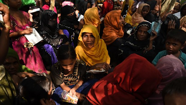 Women and children queue at a Red Cross distribution point in Burma Para refugee camp in Bangladesh. 