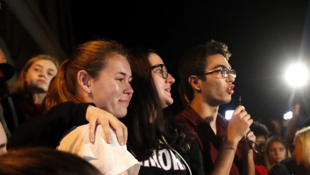 Diego Pfeiffer, a student survivor from Marjory Stoneman Douglas High School, speaking to a crowd of supporters and media, with fellow survivors Sophie Whitney, left, and Sarah Chadwick.