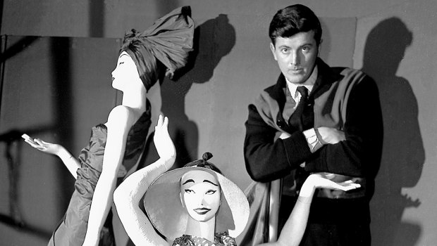 Hubert de Givenchy poses with mannequins in his shop in Paris in 1952.