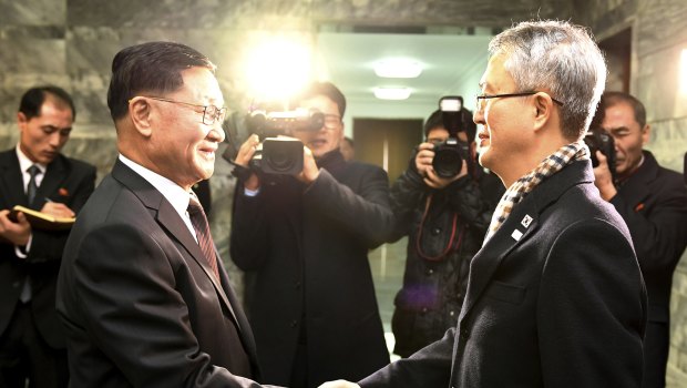 The head of the North Korean delegation, Kwon Hook Bong, shakes hands with his South Korean counterpart, Lee Woo-sung, before their meeting at the North side of Panmunjom in North Korea on Monday.