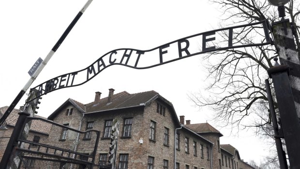 The sign Arbeit macht frei (Work makes you free) at the main gate of the former  German Nazi concentration and extermination camp Auschwitz.