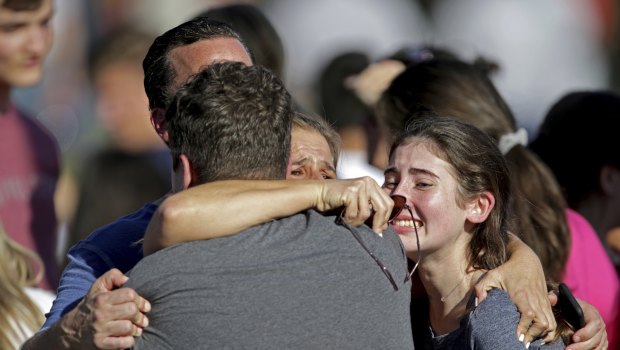 A family reunites following a shooting at Marjory Stoneman Douglas High School.