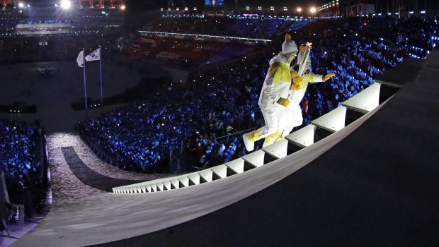North Korea's Jong Su Hyon, left, and South Korea's Park Jong-ah carry the torch during the opening ceremony of the 2018 Winter Olympics in Pyeongchang, South Korea.