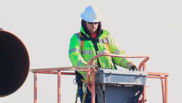 Workers unload pipes for the proposed Dakota Access oil pipeline.