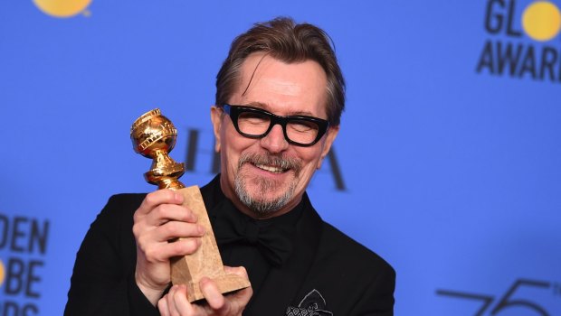 Gary Oldman poses in the press room with the award for best performance by an actor in a motion picture - drama for Darkest Hour.