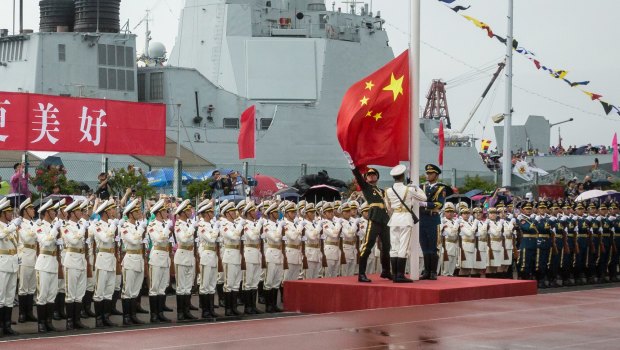 Members of the People's Liberation Army (PLA) raise a Chinese national flag during a flag raising ceremony at an open day at the Ngong Suen Chau Barracks in Hong Kong, China.