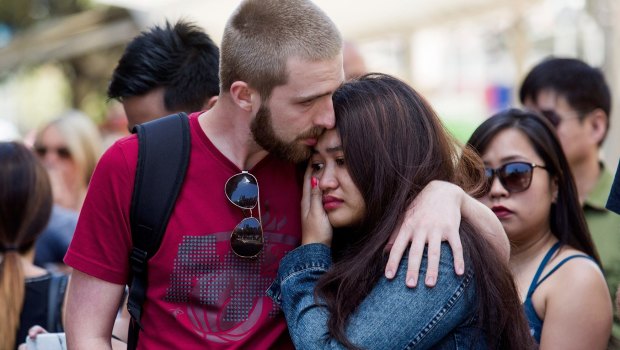 People pay their respects to the victims of the Bourke Street attack.