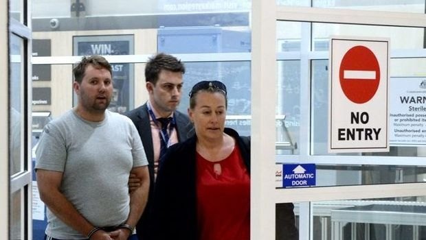 Jason Wayne Greatbatch, 35 from South Australia, arrives at Mackay airport with detectives. He is facing charges including attempted murder for an attack on Teagan Moore at Kuttabul.