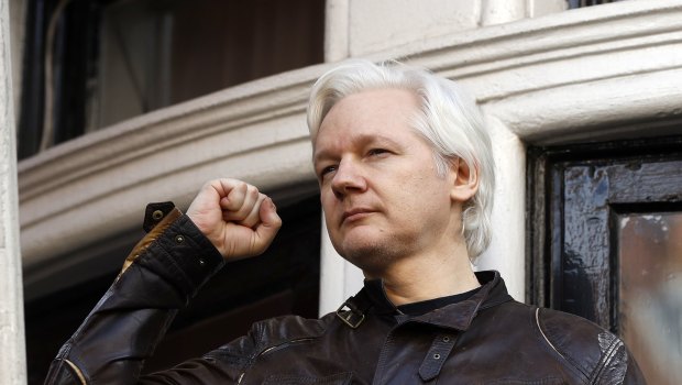 Julian Assange greets supporters outside the Ecuadorian embassy in 2017.