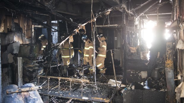 Firefighters inspect a burnt hospital after a fire in Miryang, South Korea.