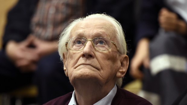 Former SS sergeant Oskar Groening looks up as he listens to the verdict of his trial at a court in Lueneburg, northern Germany, in 2015.