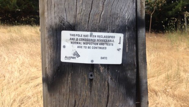 An example of a power pole that has been reclassified and temporarily left in service.