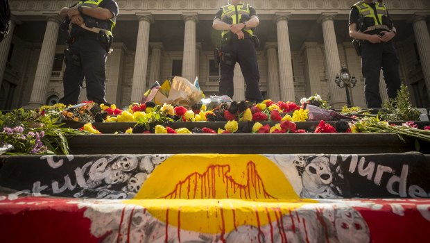 Police monitor the 'Invasion Day' rally.