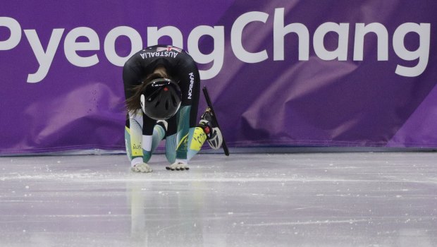 Deanna Lockett rests on the ice after crashing out.