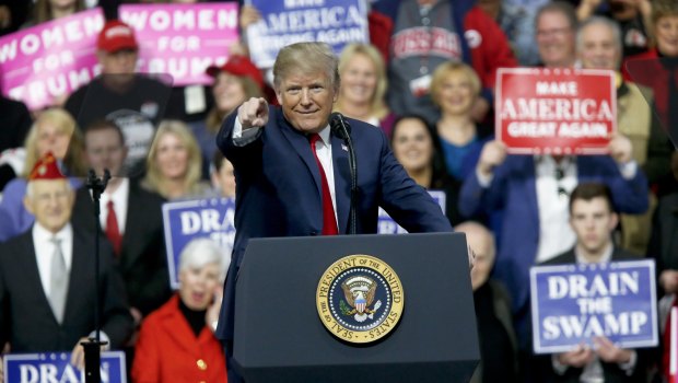 President Donald Trump at a campaign rally for Republican Rick Saccone on  Saturday, at which he mocked the idea of a commission achieving anything.