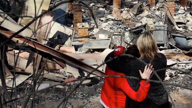 Amy Hubbard (left) with her mother, Catherine and the ruins of their home in Buena Vista Road, Winmalee, that was destroyed in a bushfire fires in the Blue Mountains on October 18, 2013.