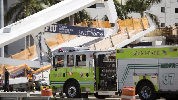 Emergency personnel responds to the collapsed pedestrian bridge in Florida.