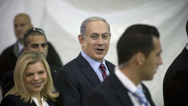 Sara, left, and Benjamin Netanyahu, centre, were questioned on Friday. 