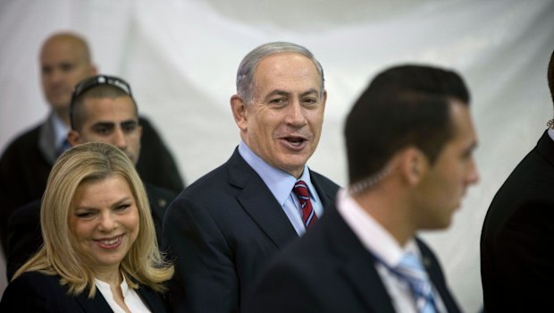 Sara, left, and Benjamin Netanyahu, centre, were questioned on Friday. 