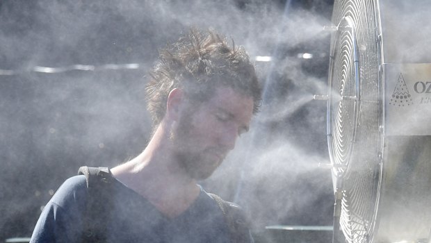 Tennis goers do their best to keep cool at the Australian Open.