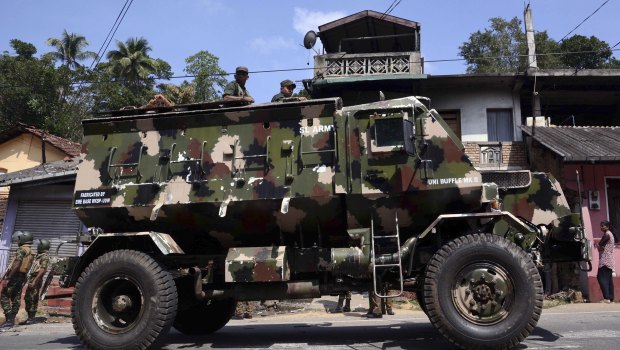 Sri Lankan army soldiers look on from an armed personnel carrier in Digana, a suburb of Kandy.