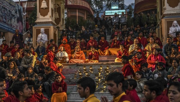 Religious students and tourists during a nightly ritual at the Parmath Niketan ashram in Rishikesh, India. 