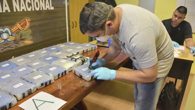 In 2016, a police officer opens up a package of cocaine found in an annex building Russian embassy in Buenos Aires, Argentina. 
