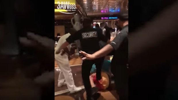 Mobile phone footage shows security guards kicking a passenger during the fight.