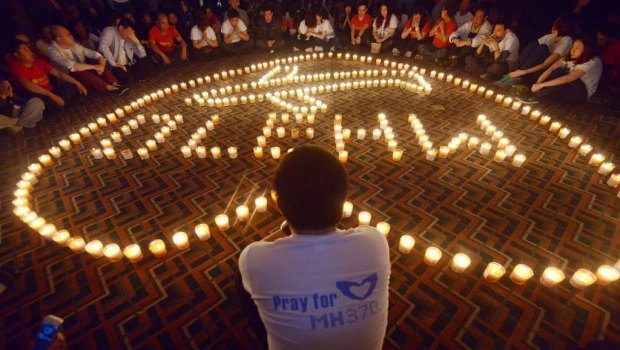 Chinese relatives of passengers on the missing Malaysia Airlines flight MH370 take part in a prayer service at the Metro Park Hotel in Beijing.