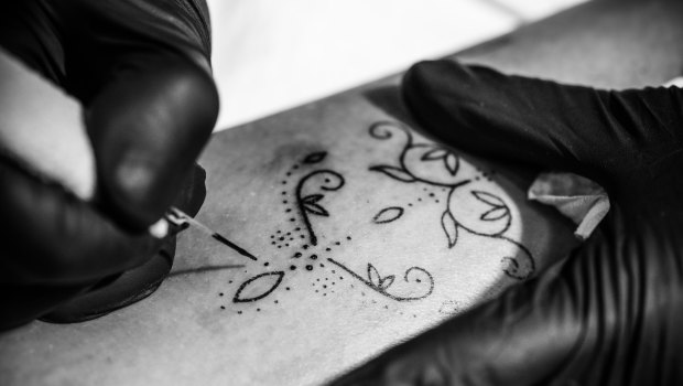 Tattoo artist Amy Unalome uses a hand-poke technique to create delicate designs.