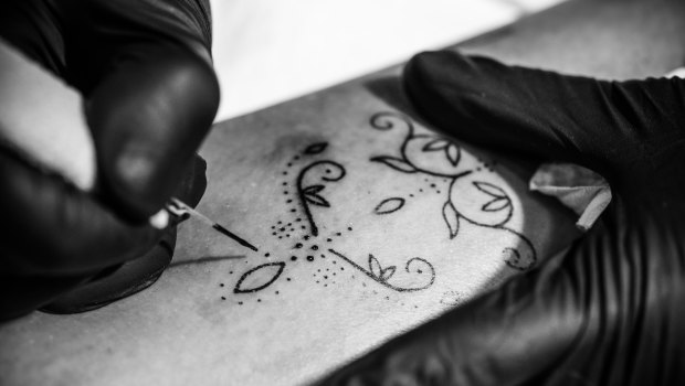 Tattoo artist Amy Unalome uses a hand-poke technique to create delicate designs.