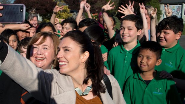 New Zealand Labour Party leader Jacinda Ardern, front right, takes a selfie with school children in Christchurch.