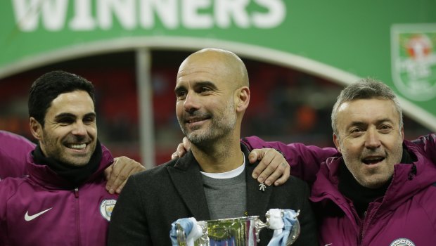 All smiles: Pep Guardiola with the League Cup.