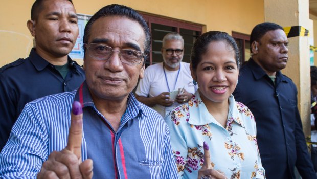 East Timorese Francisco 'Lu'Olo' Guterres, left, shows his finger to indicate he has just voted in parliamentary elections in July.