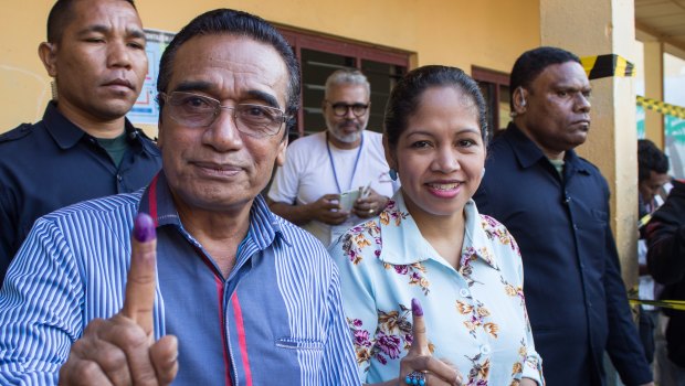 East Timorese Francisco 'Lu'Olo' Guterres, left, shows his finger to indicate he has just voted in parliamentary elections in July.