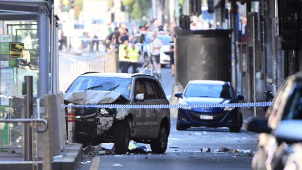 A damaged vehicle is seen at the scene of an incident on Flinders Street, in Melbourne, Thursday, December 21, 2017. A vehicle has ploughed into pedestrians in central Melbourne. (AAP Image/Joe Castro) NO ARCHIVING