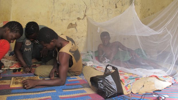 Teen migrants rest in a compound in Agadez, Niger, in December.