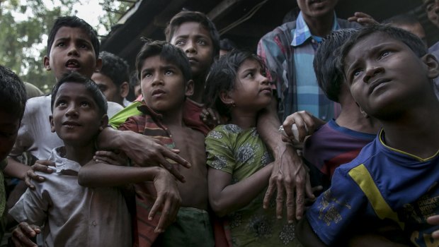 Rohingya refugees gather to receive relief supplies donated in the Leda Rohingya refugee camp in Chittagong, Bangladesh.