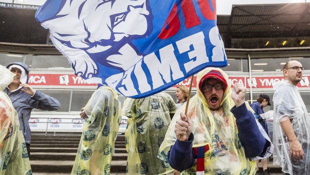 Western Bulldogs supporters donned plastic ponchos as the rain came down.