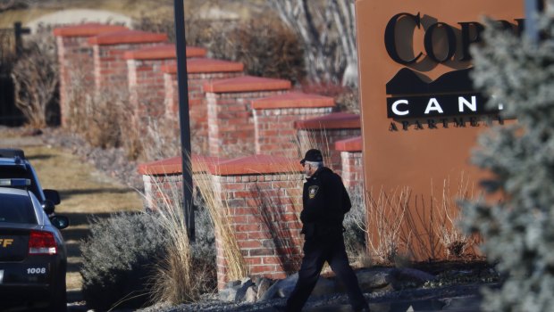 An investigator heads to the scene of shooting in Highlands Ranch, Colorado.