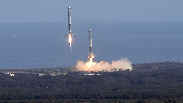 Two booster rockets from the Falcon 9 SpaceX heavy, return for a landing at the Kennedy Space Center in Cape Canaveral, Florida.