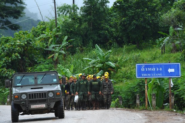 Thai army soldiers return from the base camp near Tham Luang cave.